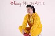 Watching sexy Jill wearing a sexy yellow shiny nylon rainwearcombination and a red shiny nylon raincoat posing for you (Pics)