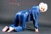 Blonde angel posing in a studio wearing sexy Blue AGU shiny nylon rainwear (Pics)