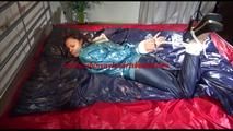 Lulu tied and gagged on a bed wearing a supersexy blue/green rainwear combination (Video)