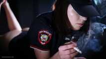 Police woman is smoking 3 strong reds in the studio