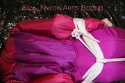 Mara tied and gagged ob a black sofa wearing a supersexy pink downwear (Pics)