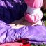 Julia tied and gagged in a shiny nylon skisuit