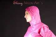 Mara wearing a sexy pink rainsuit posing infront of the camera in a studio (Pics)