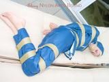 Beautiful archive girl in a blue shiny nylon rainsuit tied and gagged with tape on a sunlounger (Pics)