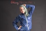 Mara posing in the studio wearing a blue rain skirt and a blue rain jacket as wellas red rubber boots (Pics)