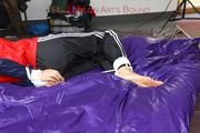 Samantha tied and gagged on bed wearing shiny nylon rainwear (Pics)