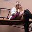 Pretty girl is relaxing outside on a rainy day with a 120mm cigarette and wearing high heels