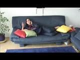 Jill lolling on a sofa wearing sexy shiny nylon rainwear (Video)