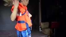 Watching sexy Sandra putting on a lifevest over a shiny nylon shorts (Video)