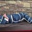 Pia tied and gagged on a princess bed wearing oldschool blue shiny downwear (Video)