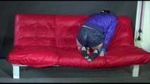 MARA tied and gagged with gymnastics bands and a ball gag - hand to feet wearing a supersexy shiny nylon shorts and rain jacket (Video)