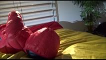 Jill tied, gagged and double-hooded on a bed wearing sexy shiny nylon rain pants and a down jacket (Video)