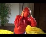 Lucy enjoying herself in shiny nylon rainwear double hooded on bed (Video)