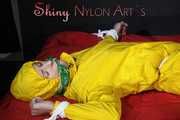 Watching sexy Pia being tied and gagged with ropes on a bed and a clothgag wearing sexy yellow shiny nylon rainwear (Pics)