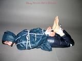 One of our archive girls tied and gagged in shiny nylon rainwear