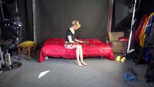 *** Sexy MIA wearing a green shiny nylon shorts and a black top ties and gagges herself with cuffs and a clothgag on a bed (Video)***