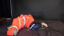 Sexy Sonja being tied, gagged and hooded on a bed with belts and a cloth gag wearing shiny nylon rain pants and a rain cape (Video)