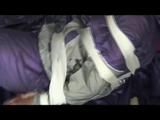 A video with Alina tied and gagged in a shiny purple and silver PVC suit
