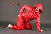 Petra posing in a studio wearing a supersexy red rainwear combination (Pics)