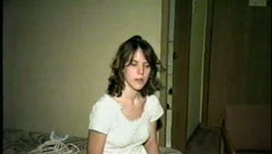 HEATHER IS F0RCED TO TAPE UP HER LEGS AND BARE FEET & IS THEN PANTY STUFFED AND WRAP GAGGED THEN HOG-TIED WITH TAPE ON THE BED (D52-14)