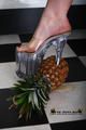Heels crushing pineapple in the kitchen