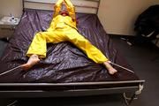 Pia tied and gagged in a shiny nylon rainsuit 