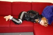 Samantha bound and gagged in shiny nylon rainwear