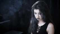 Goth girl with black eyes occasionally prefers dragging a 120mm cigarette