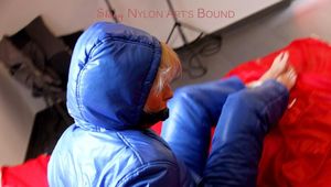 Pia tied and gagged in a shiny nylon skisuit