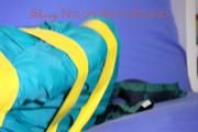 Mara tied and gagged with tape on a sofa wearing a supersexy shiny blue rain pants and a grren rain jacket (Pics) 