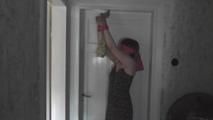 Kim tied to the door