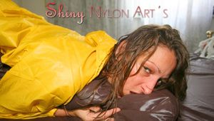 Stella lolling on bed wearing sexy shiny nylon rainwear (Pics)