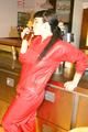 Jill posing sexy in an bar wearing sexy red shiny nylon rainwear (Pics)