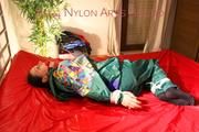 Lucy tied and gagged on bed wearing a sexy green rainwear combination (Pics)