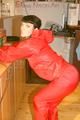 Jill posing sexy in an bar wearing sexy red shiny nylon rainwear (Pics)