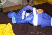 Lucy taped, hooded and gagged on bed wearing sexy blue rainwear (Pics)