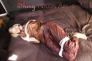 Watching sexy Sonja being tied and gagged on a bed with ropes and a clothgag wearing a supersexy shiny brown nylon pants and a brown rain jacket (Pics)