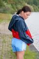 Sexy archive girl walking on a lake wearing a sexy shiny nylon shorts and an oldschool rain jacket (Pics)