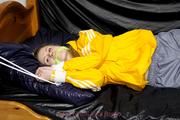 Samanthy bound and gagged in shiny nylon rainwear