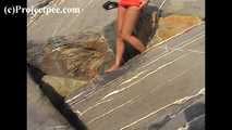 016169 Eve Takes A Discrete Pee On The Rocks