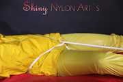 Watching sexy Pia being tied and gagged with ropes on a bed and a clothgag wearing sexy yellow shiny nylon rainwear (Pics)