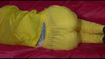 Watching Mara putting on sexy yellow shiny nylon rainwear lolling on the sofa (Video)
