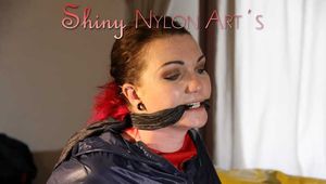Watching sexy Jill being tied and gagged with ropes and a ballgag on a bed wearing a sexy red shiny nylon shorts and an oldschool rain jacket (Pics)