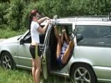 One of our archive girls ties and gagges the other one outdoor in car wearing shiny nylon shorts (Video)