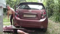 Mistress Jenna stands on the slave with a car while smoking in the slave's mouth A