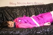 Mara tied and gagged ob a black sofa wearing a supersexy pink downwear (Pics)