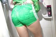 Sonja oiling and rinsing herself in the shower wearing a supersexy green shiny nylon shorts and rain jacket (Pics)