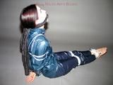 One of our archive girls tied and gagged in shiny nylon rainwear