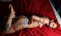 Nicole hogtied on bed