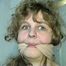 19 Yr OLD SINGLE MOM RONI IS WRAP CLEAVE GAGGED WITH AN ACE BANDAGE, HANDGAGGED, MOUTH STUFFED, BALL-GAGGED & TIED BACKWARDS TO A CHAIR (D53-9)